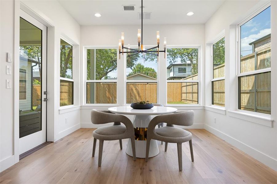 Sunroom / solarium featuring a chandelier, wood finished floors, and recessed lighting Sunroom / solarium featuring a chandelier, wood finished floors, and recessed lighting