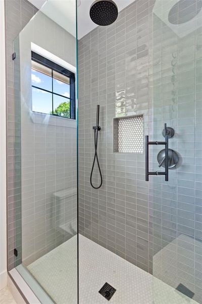 Bathroom featuring a tile shower
