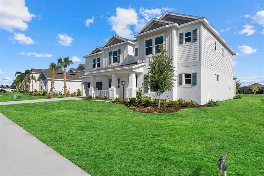 Front exterior of a new home in Park East at Azario, Bradenton, FL, highlighting curb appeal (Image 25). Front exterior of a new home in Park East at Azario, Bradenton, FL, highlighting curb appeal (Image 25).