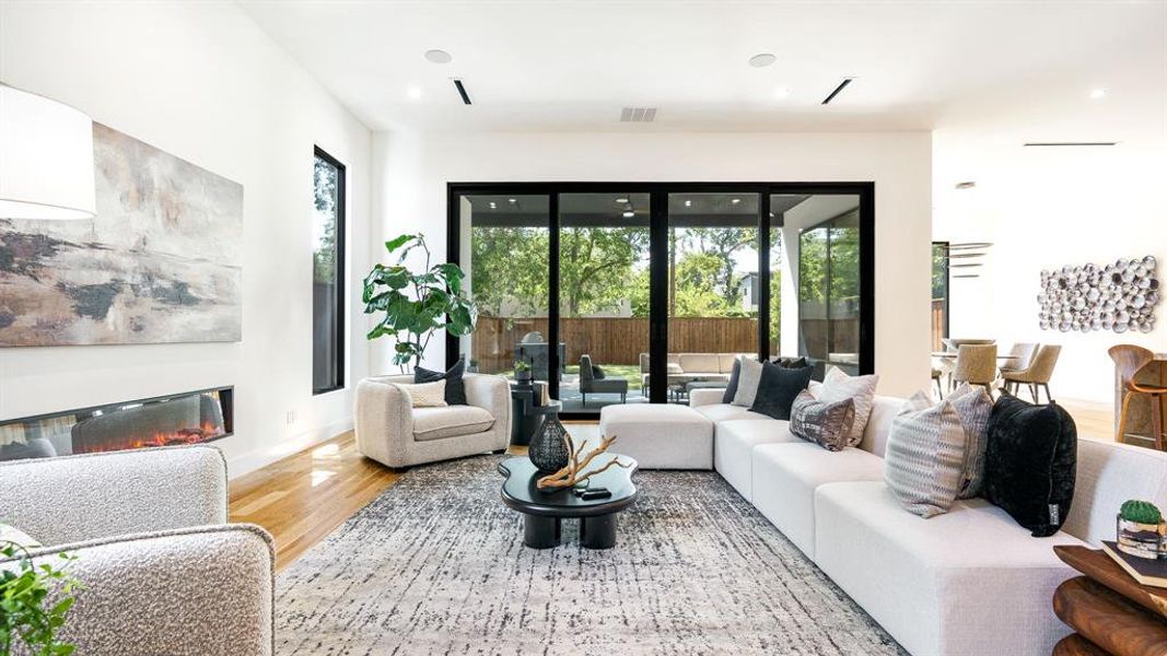 Living room featuring light wood-type flooring and a healthy amount of sunlight