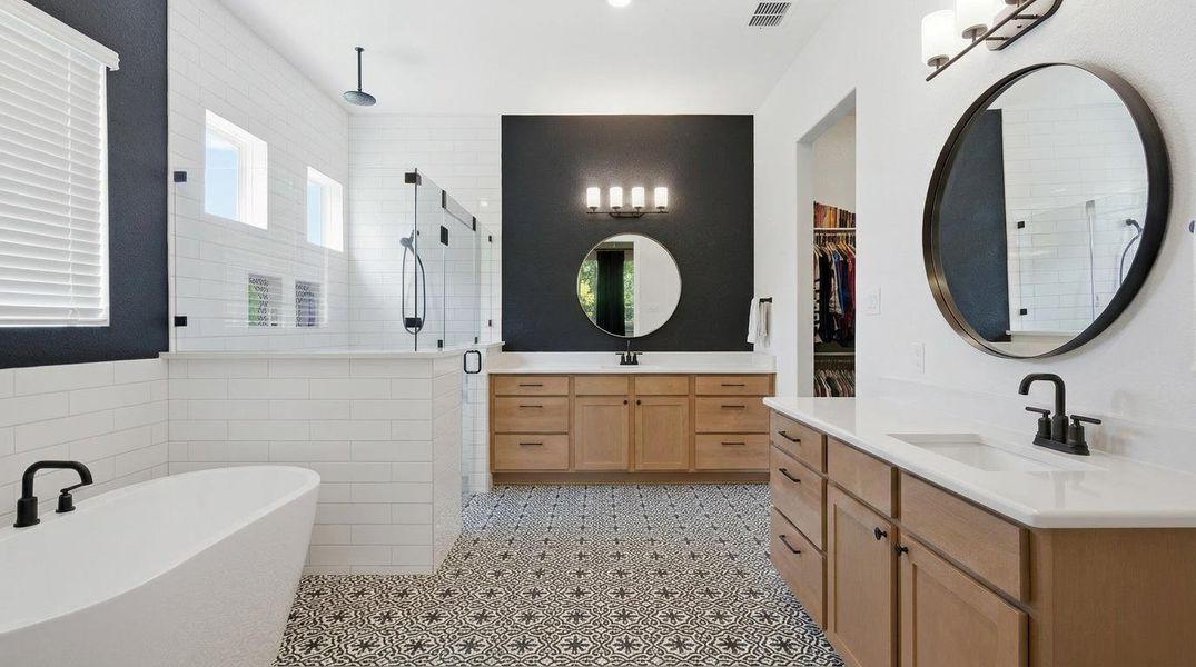 Luxurious bathroom retreat with a standalone soaking tub and a spacious walk-in shower. Luxurious bathroom retreat with a standalone soaking tub and a spacious walk-in shower.
