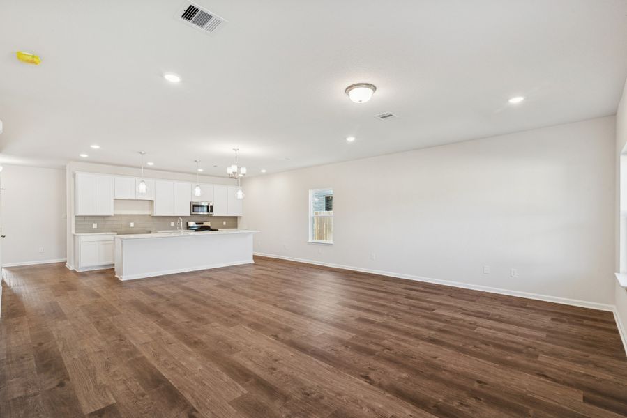 The Crawford- Family Room into Dining and Kitchen. Home under construction, sample photo used for illustrative purposes only, colors and options will vary.