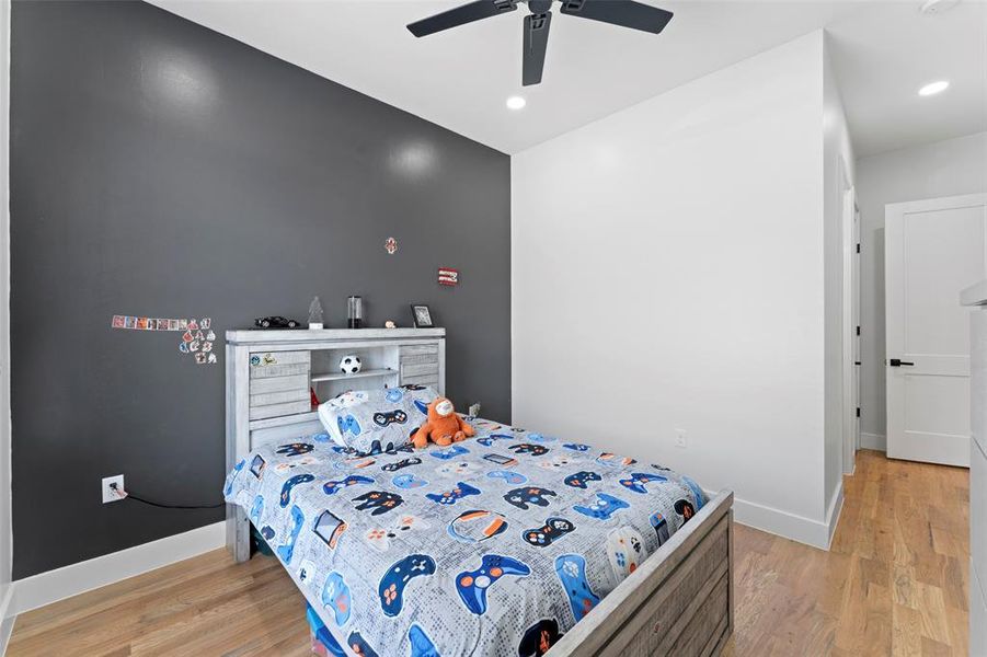 Bedroom with light wood-style floors, ceiling fan, and recessed lighting Bedroom with light wood-style floors, ceiling fan, and recessed lighting