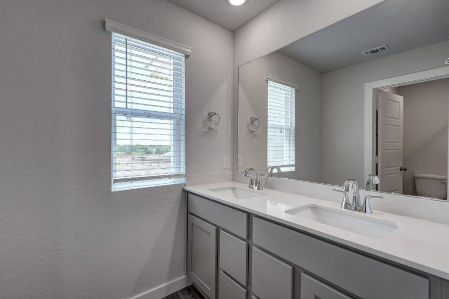 A bathroom with a large mirror. A bathroom with a large mirror.