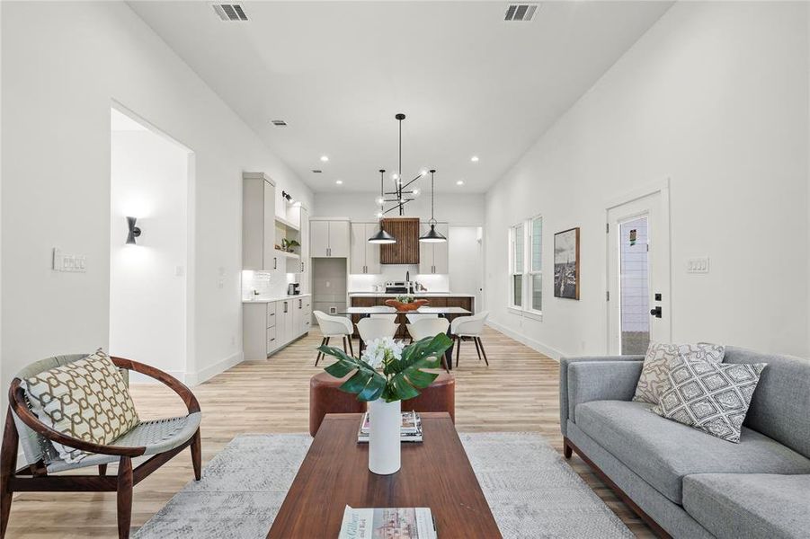 Living area featuring light wood-style floors and recessed lighting