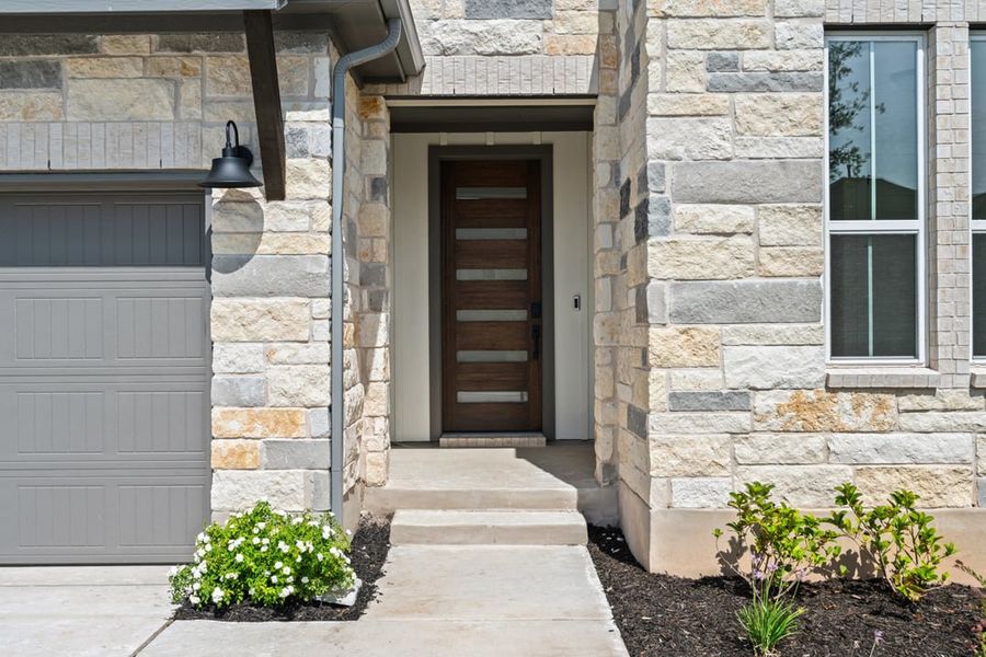 Front exterior of a new home in Park Collection at Lariat, Liberty Hill, TX, highlighting curb appeal (Image 24). Front exterior of a new home in Park Collection at Lariat, Liberty Hill, TX, highlighting curb appeal (Image 24).