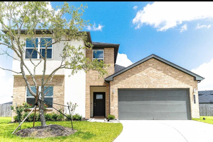 Front exterior of a new home in Tamarron, Katy, TX, highlighting curb appeal (Image 2).