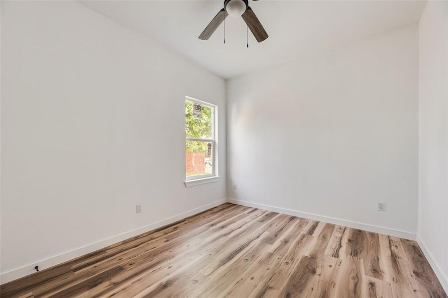 Unfurnished room with light wood-type flooring and ceiling fan