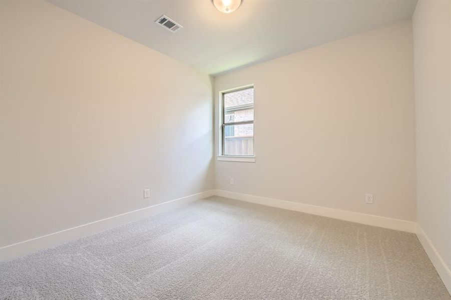 Empty room with light colored carpet and vaulted ceiling Empty room with light colored carpet and vaulted ceiling