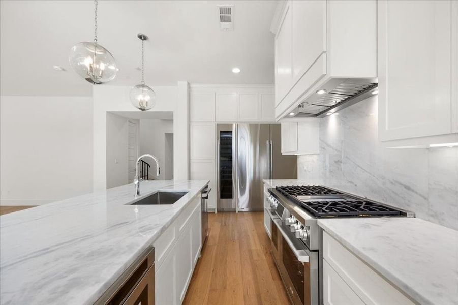 Wine column and sixty inch refrigerator and freezer columns, gas range with double oven and commercial venting to outside, 6 burner and griddle. A chef's delight!