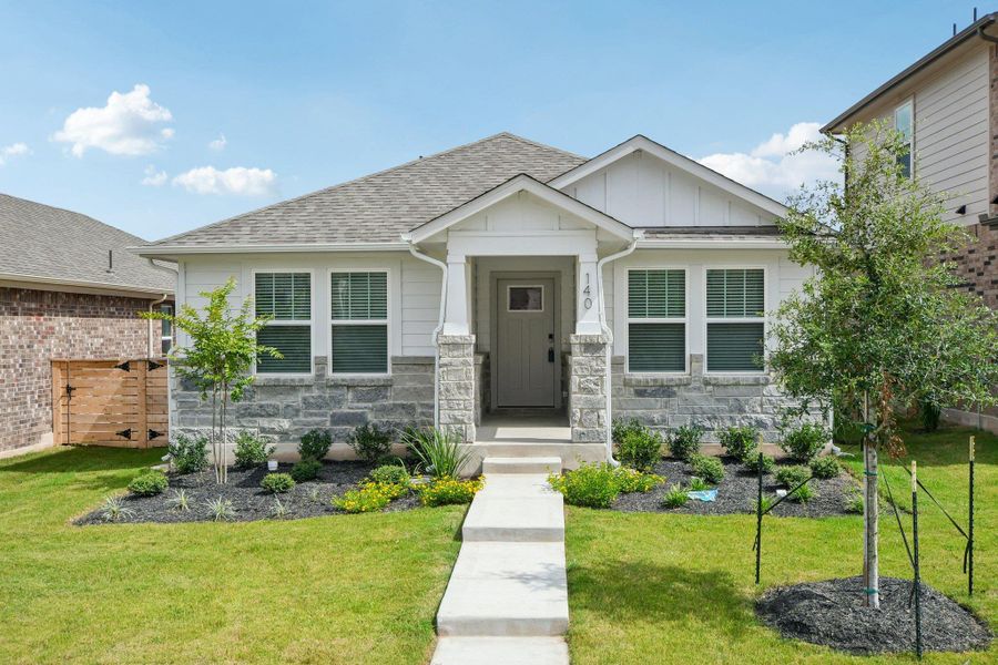 View of front of house with a shingled roof, board and batten siding, stone siding, and a front lawn View of front of house with a shingled roof, board and batten siding, stone siding, and a front lawn