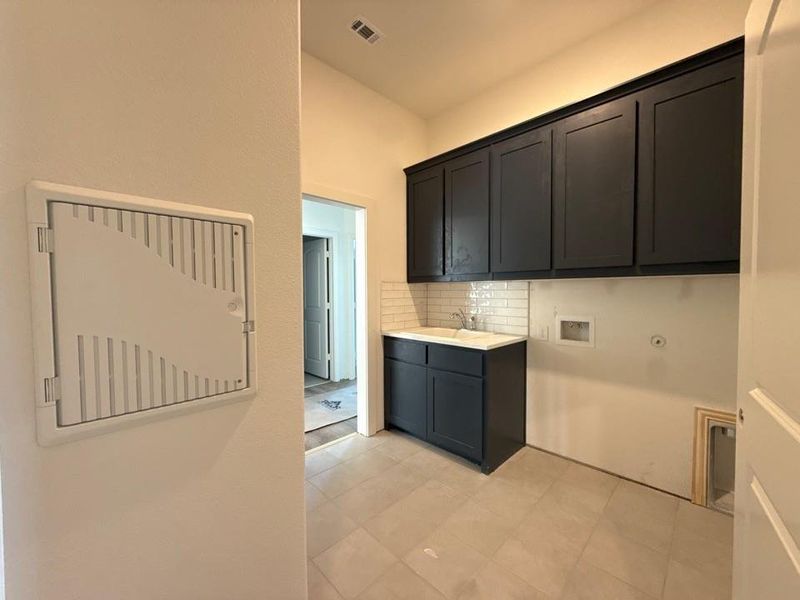 Laundry area featuring washer hookup, cabinet space, and hookup for a gas dryer