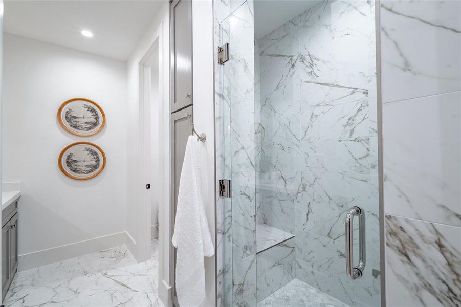 Bathroom featuring vanity, an enclosed shower, and toilet