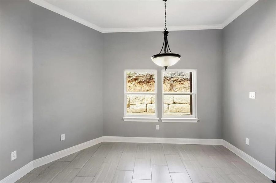 Unfurnished dining area featuring ornamental molding