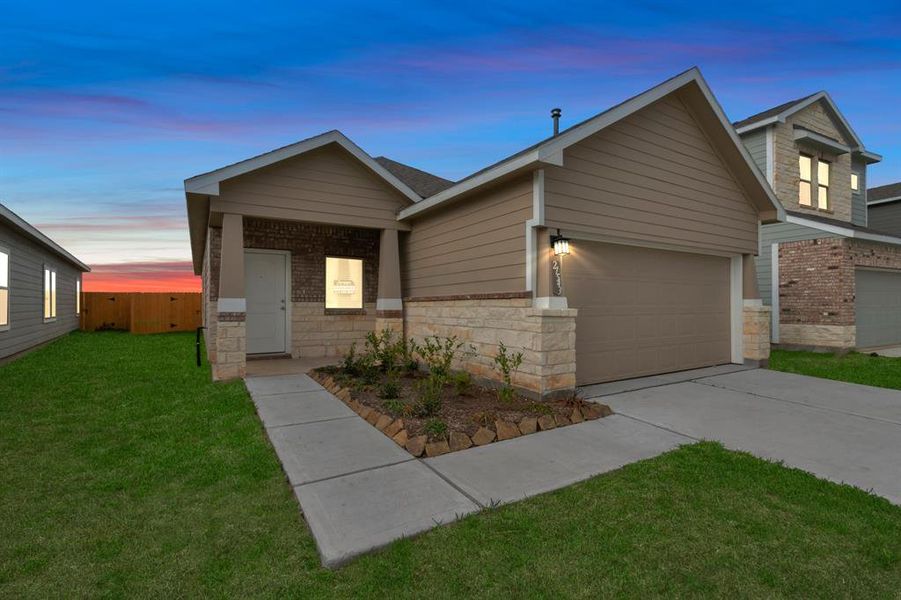 Experience the enchanting curb appeal of this new construction home in Aldine Pines, perfectly captured at twilight. The warm glow from the home's exterior lighting highlights the charming brick and stone accents, creating a welcoming ambiance that’s perfect for evening gatherings. This stunning facade is just the beginning of the quality and style you’ll find inside. **This image is from another Saratoga Home - Wren floorplan.**