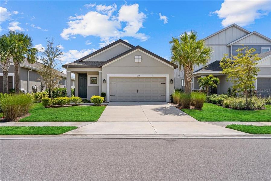 Front exterior of a new home in Park East at Azario, Bradenton, FL, highlighting curb appeal (Image 24).