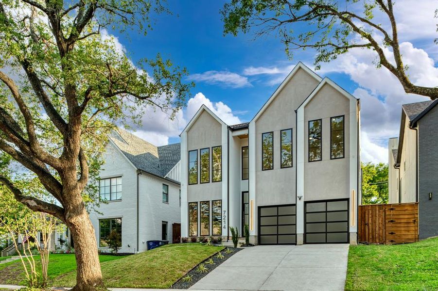 View of front of house with a front lawn and a garage