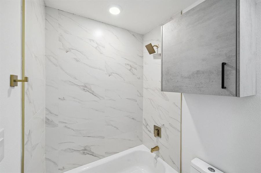 Full bathroom featuring toilet and shower / bath combination