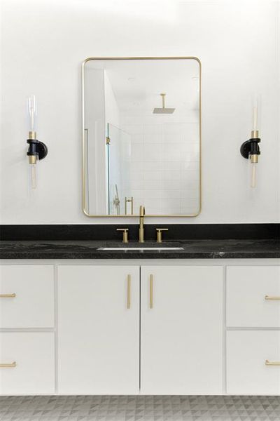 Bathroom with a shower, vanity, and tile floors