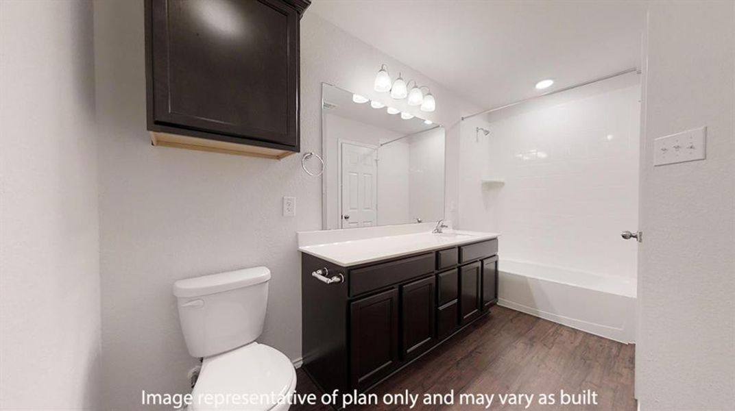 Bathroom with double vanity, bathing tub / shower combination, and dark wood finished floors Bathroom with double vanity, bathing tub / shower combination, and dark wood finished floors