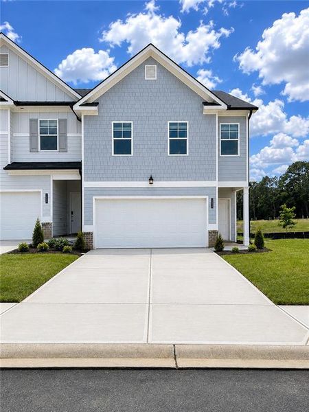Front exterior of a new home in Sandtown Falls, South Fulton, GA, highlighting curb appeal (Image 1). Front exterior of a new home in Sandtown Falls, South Fulton, GA, highlighting curb appeal (Image 1).