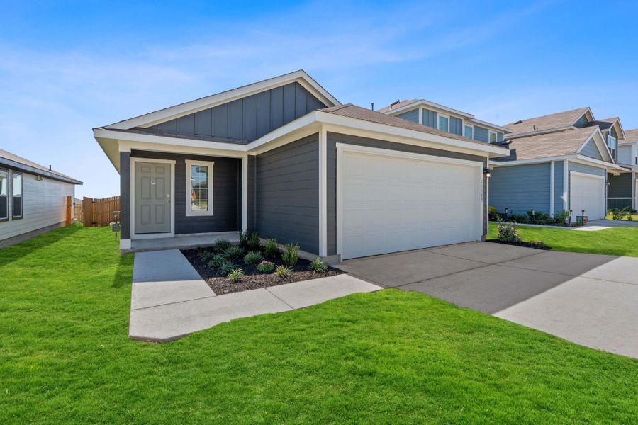 View of front of property with board and batten siding, concrete driveway, and a garage