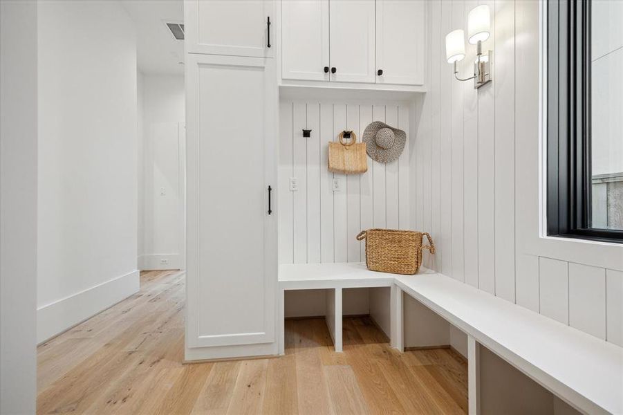 MUDROOM: This practical yet stylish space serves as the gateway to functionality, offering a dedicated area to effortlessly transition from the outdoors to the comfort of home. Whether returning from a day of outdoor adventures or simply seeking a practical space to organize belongings, this mudroom is a sanctuary of orderliness.