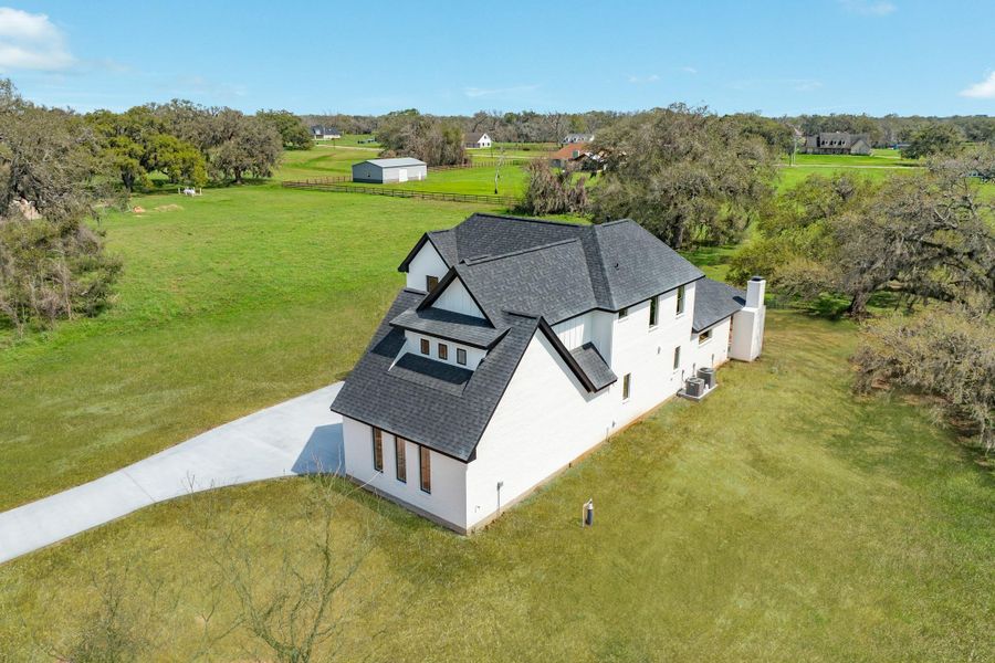 Front exterior of a new home in , Angleton, TX, highlighting curb appeal (Image 25).