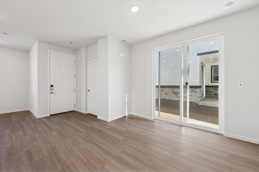 A room with white walls and a glass door.
