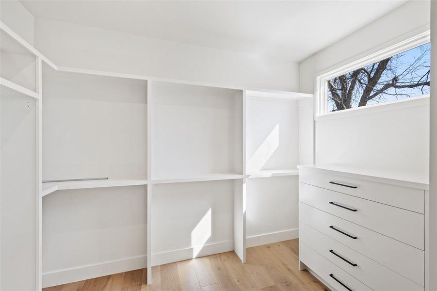 Experience the epitome of functionality and style in the primary walk-in closet, boasting built-in storage solutions that elevate the art of organization to new heights.