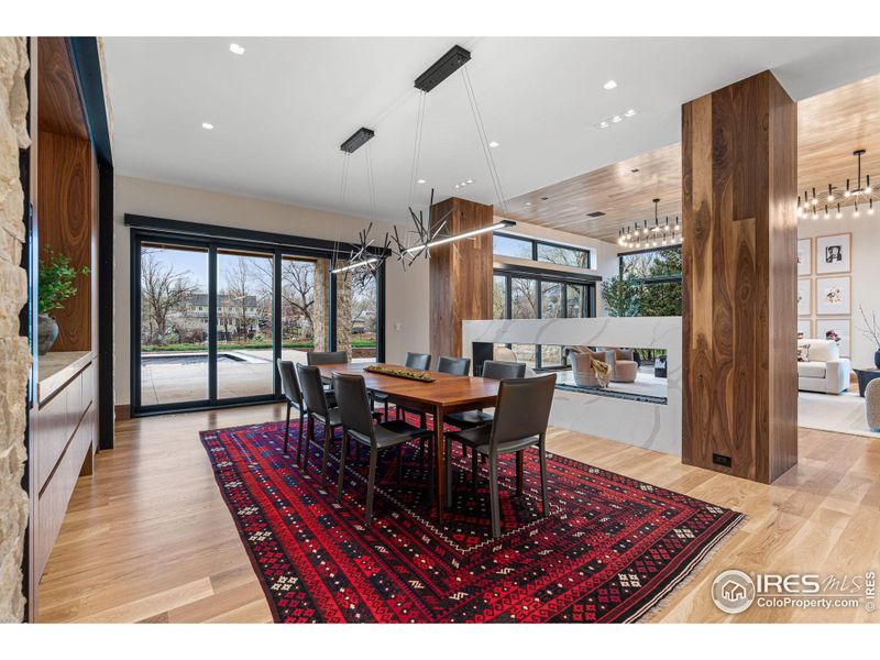 Similar to the adjacent living room, the dining room also brings the outdoors in with another multi-panel sliding glass door opening to the south facing backyard. Includes a Hubbardton Forge Cascade LED Pendant chandelier.