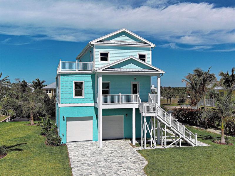 Front exterior of a new home in , Placida, FL, highlighting curb appeal (Image 31). Front exterior of a new home in , Placida, FL, highlighting curb appeal (Image 31).
