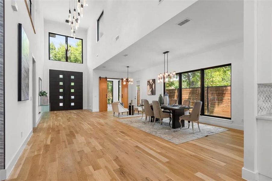 Grand entry featuring a double-height ceiling and light wood-finish flooring Grand entry featuring a double-height ceiling and light wood-finish flooring