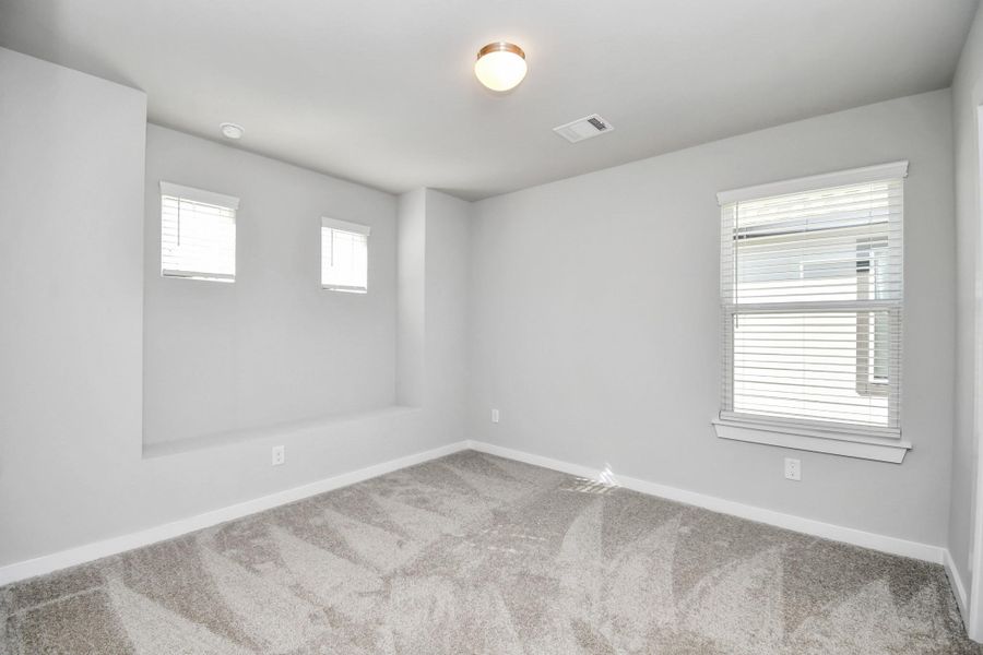 Secondary bedroom features plush carpeting, large windows that let in plenty of natural light, bright paint, and spacious closets. Secondary bedroom features plush carpeting, large windows that let in plenty of natural light, bright paint, and spacious closets.