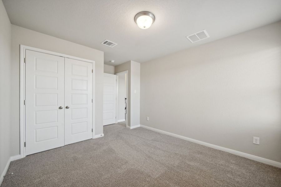 Guest bedroom in the Matador floorplan in the Meritage Homes community.