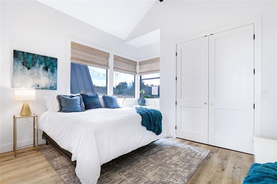 As you step into the primary bedroom, you'll be immediately captivated by the natural light that bounces off the wood floors.