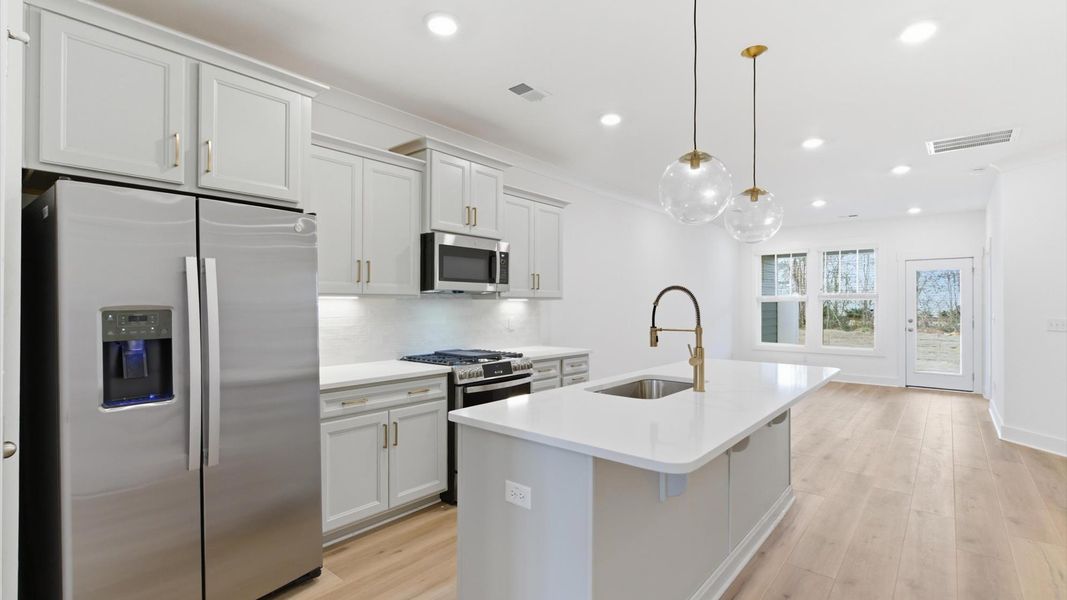First-rate kitchen with functional layout, designer pendant lighting, and a large center island