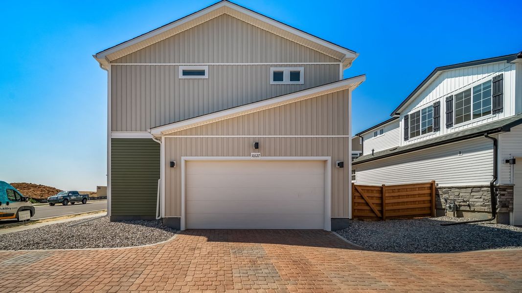Front exterior of a new home in Reunion, Commerce City, CO, highlighting curb appeal (Image 23). Front exterior of a new home in Reunion, Commerce City, CO, highlighting curb appeal (Image 23).