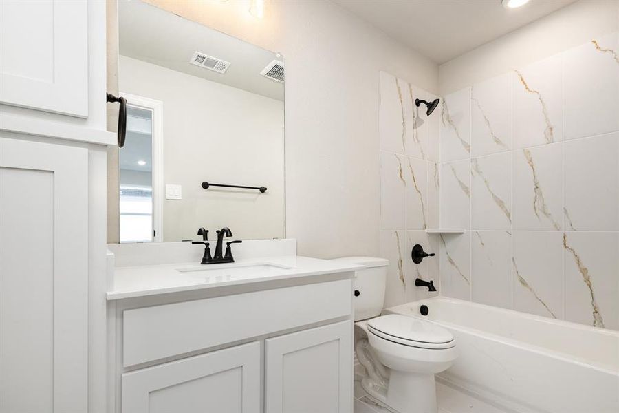 Full bathroom featuring vanity, shower / bathtub combination, and recessed lighting