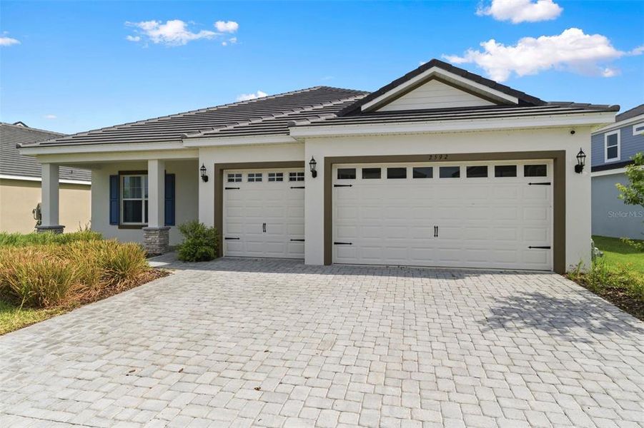 Front exterior of a new home in Tamarack at Two Rivers, Zephyrhills, FL, highlighting curb appeal (Image 29).