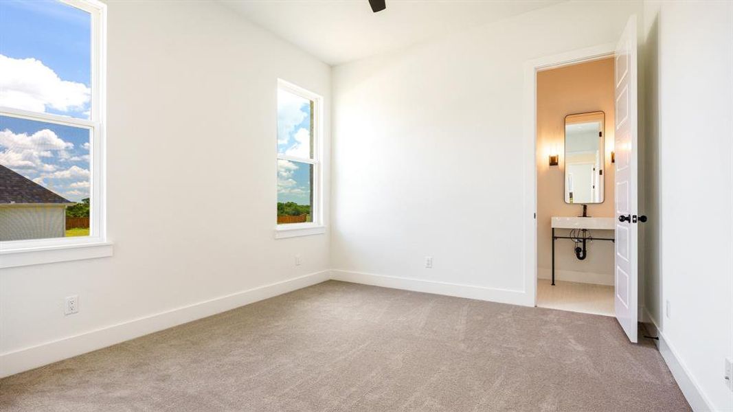 Unfurnished bedroom with light carpet and ceiling fan