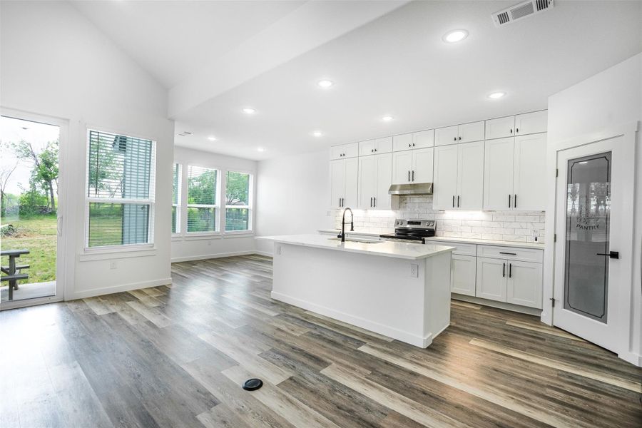 A well-appointed kitchen boasts sleek appliances and an inviting island, perfect for culinary adventures. A well-appointed kitchen boasts sleek appliances and an inviting island, perfect for culinary adventures.