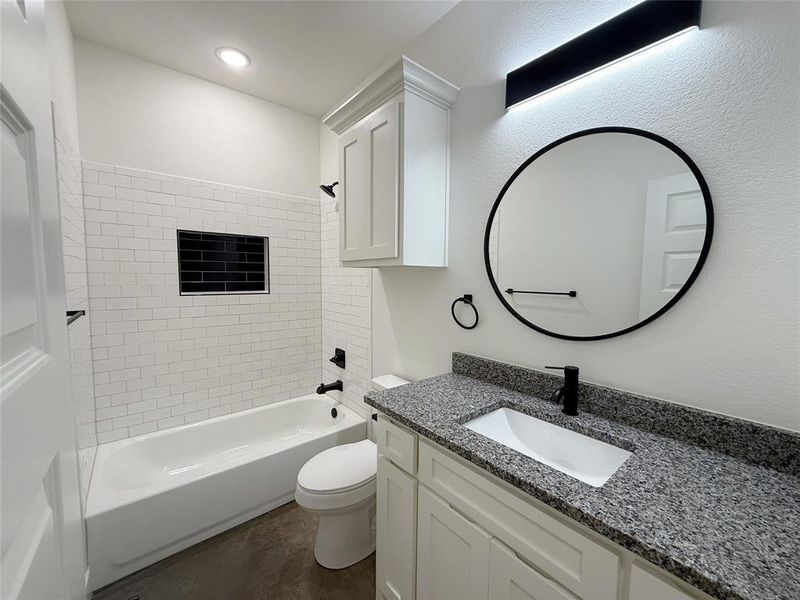 Bathroom featuring vanity and  shower combination