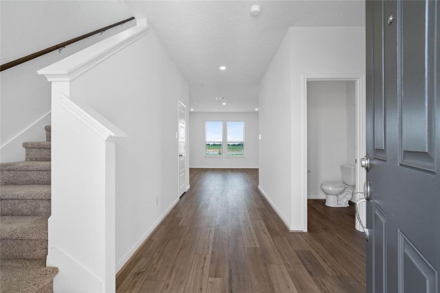 Upon entering, the stunning Layton Lake vinyl plank flooring in Driftwood captures the eye and makes the space bright and inviting. Upon entering, the stunning Layton Lake vinyl plank flooring in Driftwood captures the eye and makes the space bright and inviting.