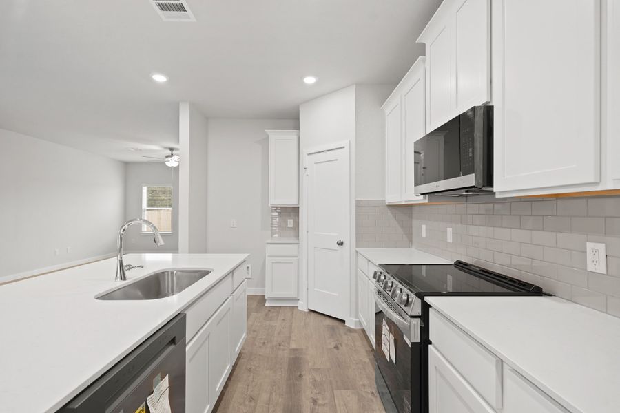 A kitchen with white cabinets. A kitchen with white cabinets.