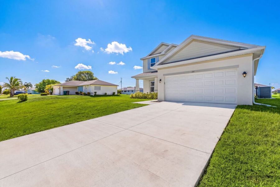 Front exterior of a new home in Cape Coral, Cape Coral, FL, highlighting curb appeal (Image 2). Front exterior of a new home in Cape Coral, Cape Coral, FL, highlighting curb appeal (Image 2).