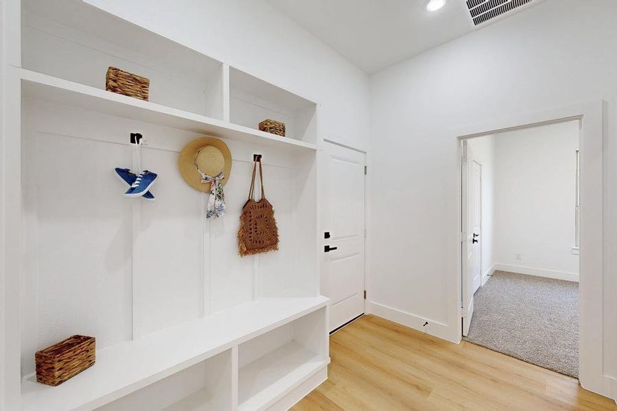 Mudroom featuring light wood-type flooring and recessed lighting