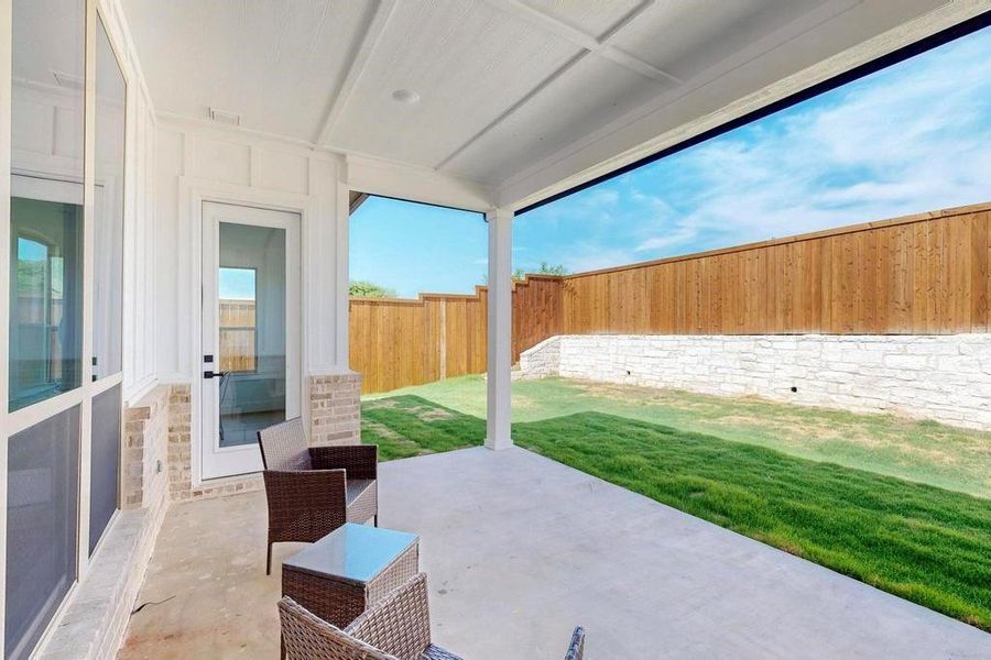 Fenced backyard with a patio