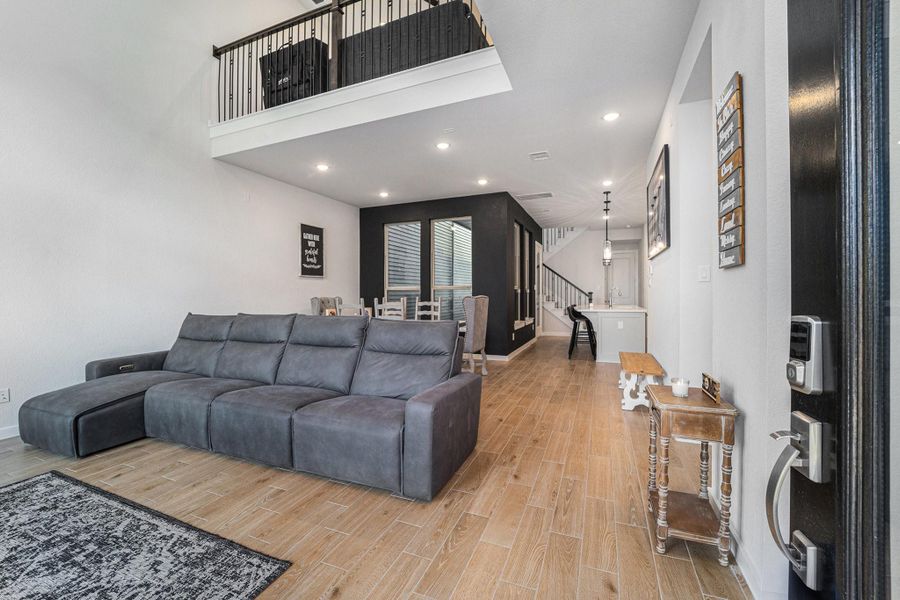 Bright, open entry flows into living and dining with luxury vinyl plank flooring.