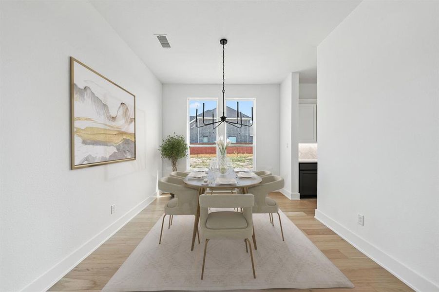 Dining room with a chandelier and light wood-type flooring